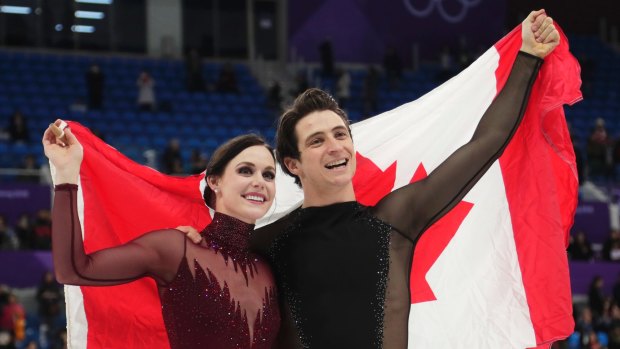Tessa Virtue and Scott Moir of Canada celebrate their gold medal.
