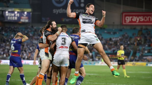 Magic moment: Aaron Woods, Michael Chee-Kam and Mitch Moses of the Tigers celebrate.