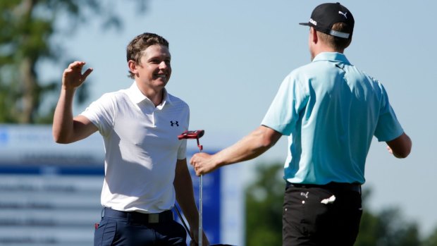 Australian Cameron Smith (left) and Jonas Blixt of Sweden react after putting in to win in a sudden-death play-off.