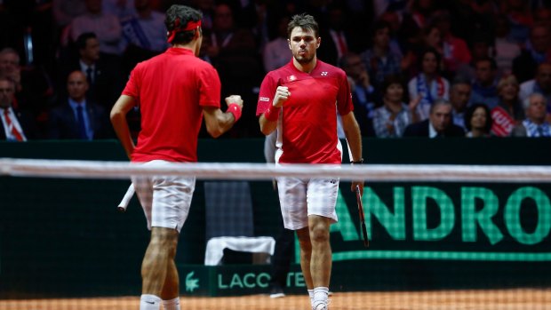 One win away: Roger Federer (left) and Stan Wawrinka took care of business in the doubles, putting Switzerland up 2-1 in the Davis Cup final.