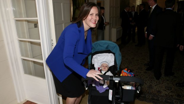 Small Business Minister and Assistant Treasurer Kelly O'Dwyer arrives for the swearing-in ceremony with daughter Olivia on Monday.