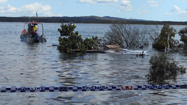 Divers inspect the collapsed area of beach at Inskip Point north of the Sunshine Coast.