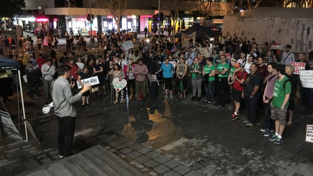 Rally organiser Tim Arnot, from the Refugee Action Collective, addresses the crowd in King George Square on Friday night.