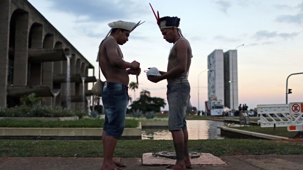 Indigenous tribe members attend a demonstration against Rousseff's impeachment in Brasilia on Wednesday.