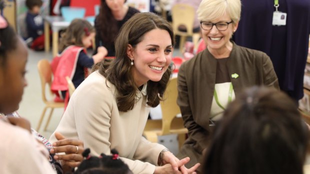 Britain's Kate, the Duchess of Cambridge speaks to children during a visit to the Hornsey Road Children's Centre in London.