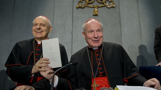 Cardinals Lorenzo Baldisseri, left, and Christoph Schoenborn show a copy of the post-synodal apostolic exhortation ' Amoris Laetitia ' during a press conference at the Vatican.