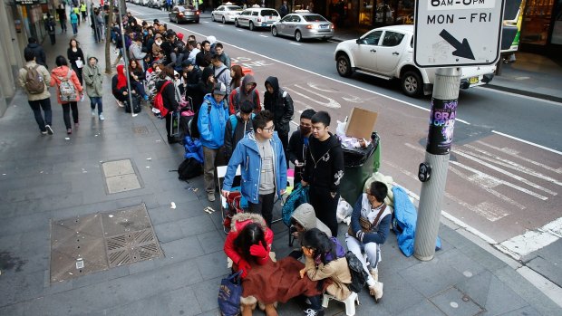 People queue for an iPhone in Sydney last year. Imagine giving the last person a phone first.