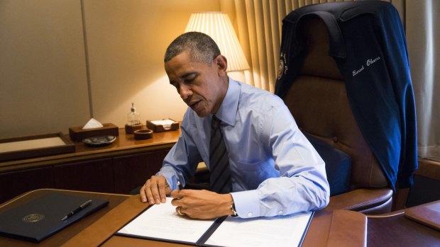 US President Barack Obama signs two Presidential Memoranda associated with his executive actions on immigration.