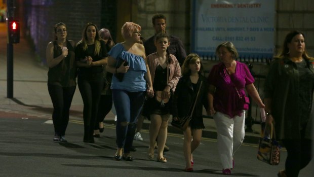 Members of the public depart Manchester Arena following a suicide bombing after Ariana Grande had performed.