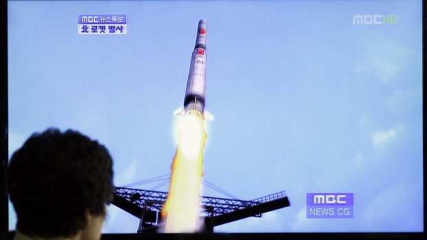 A South Korean woman watches a TV news report showing a computer generated image of North Korea's long-range rocket at Seoul train station in 2012.