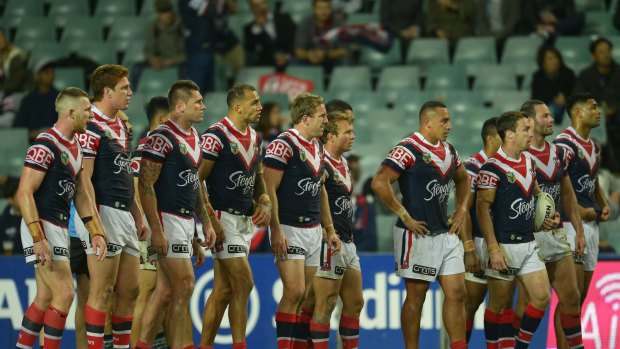 Plenty of spare seats: Roosters players show their dejection during the NRL qualifying final against the Storm at a half full Allianz Stadium.