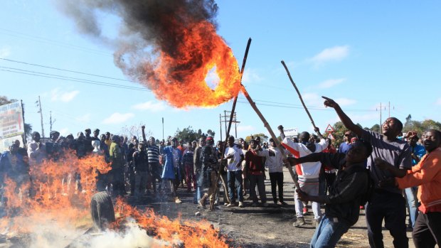 Rioters battle with Zimbabwean police in Harare.