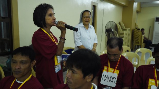 'The church is trying to do what it can because this is an issue of morality': addict Soledad Pangilinan addresses the San Roque group with her partner Manuel Tanjutco by her side.