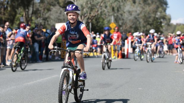 Emma Bennett, of Pambula Beach, rides in the bike leg of the Weet-Bix Kids TRYathlon at the Australian Institute of Sport.