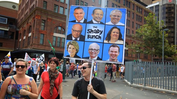 Protesters march against the Abbott Government and its policies at Town Hall and George Street on Sunday in Sydney, Australia.