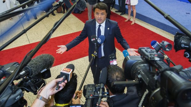 Italian Prime Minister Matteo Renzi talks to reporters in the European Council headquarters after the first day of a European Union leaders summit in Brussels on Thursday. 