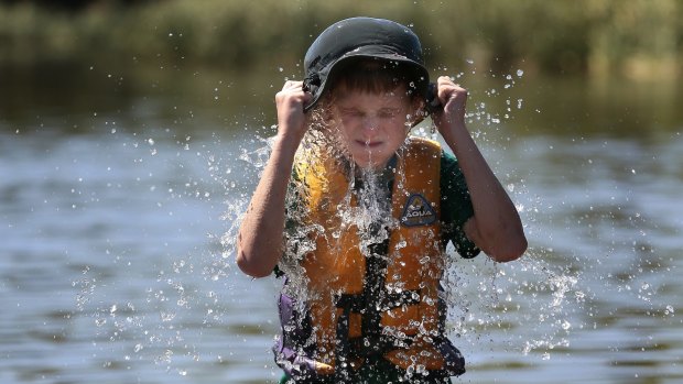 Chapman's Dylan Kirsten, 11, cools off in Lake Burley Griffin during the School Holiday Sailing School Tackers Program  at the Canberra Yacht Club. 