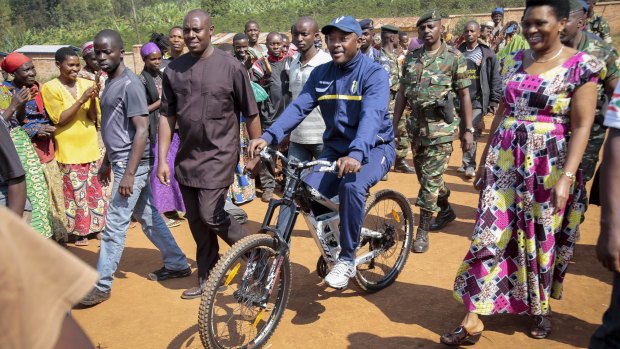 President Pierre Nkurunziza rides a bicycle to cast his vote in the presidential election.