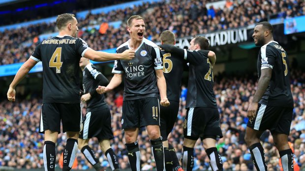 Foxes in the hunt: Leicester City's Marc Albrighton (centre) celebrates after Robert Huth scores his side's third goal against Manchester City.