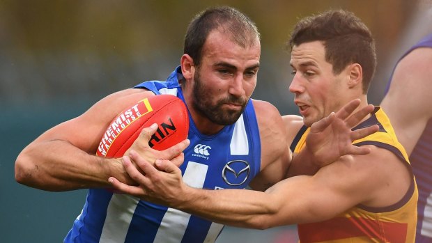Ben Cunnington fends off Adelaide's  Jake Kelly 