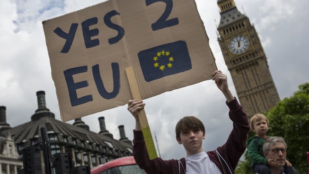 A group of young people gather to protest at Parliament Square in London the day after a majority of the British public voted to leave the European Union.