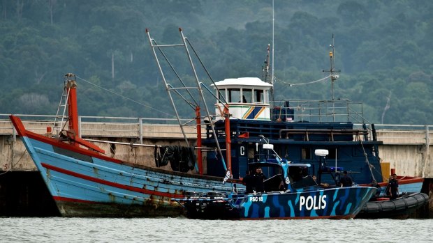 Malaysian maritime police inspect one of the boats which carried Rohingya and Bangladeshi migrants in Langkawi.