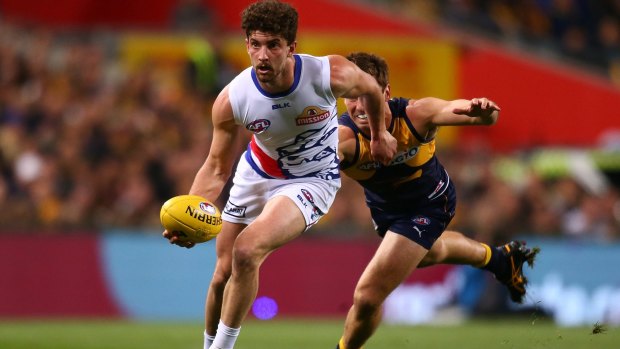 Tom Liberatore helps the Bulldogs to an elimination final win over West Coast last year. A last-round wildcard weekend could radically re-shape the first week of finals.