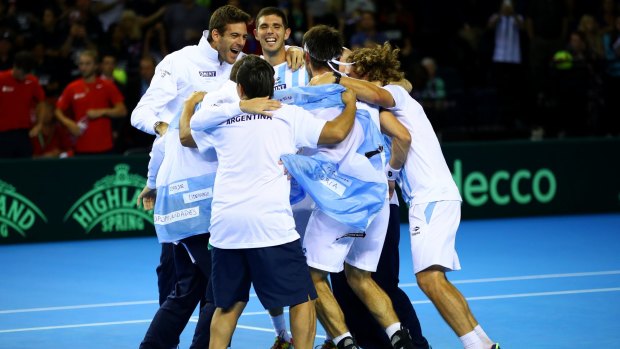 Party time: Leonardo Mayer is mobbed by his Argentina teammates as they secured a spot in the Davis Cup final.