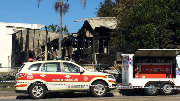 Emergency crews outside the burnt remains of the house.