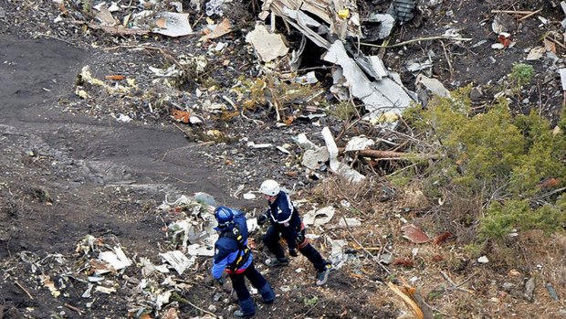 French investigators sift through wreckage at the crash site.