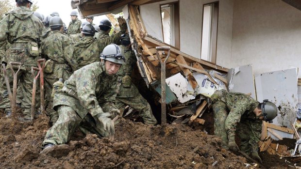 Members of Japan's Self-Defence Force search for missing people in Minamiaso, Kumamoto prefecture, on Monday. 
