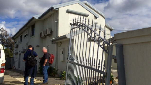 AFP officers outside Richard Vong's house in the Melbourne suburb of Thomastown, which was raided on Wednesday.