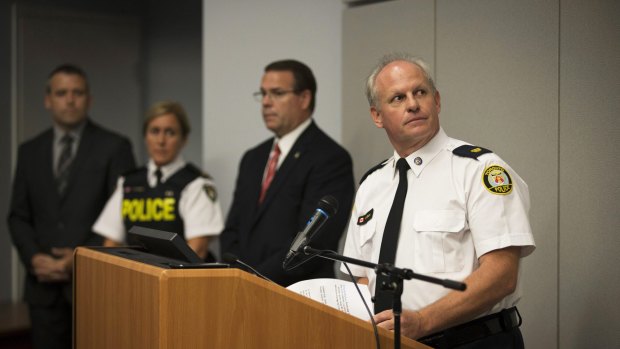 Toronto Police Services Superintendent Bryce Evans, right, speaks to the media regarding the investigation into the AshleyMadison.com breach.