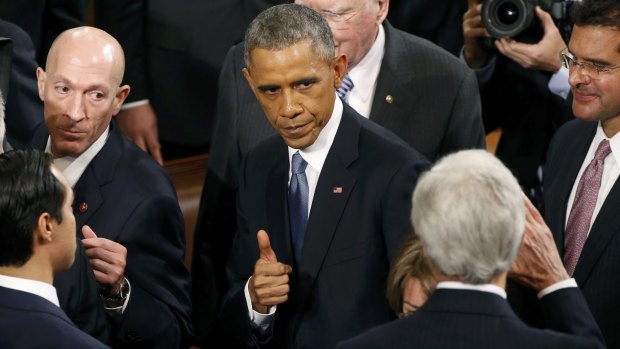 Searching for a legacy: President Barack Obama gives a thumbs up to Secretary of State John Kerry after his State of the Union address.