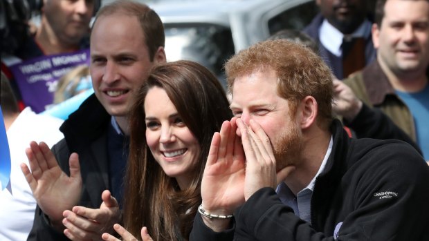 Prince William, Kate and Prince Harry cheer on runners at the finishing line.