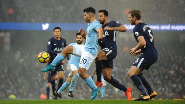 Sergio Aguero and Mousa Dembele battle for the ball.
