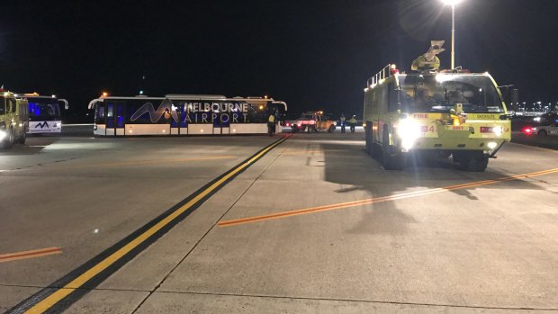 A police vehicle on the tarmac after a man allegedly tried to enter the cockpit of Malaysia Airlines Flight MH128.