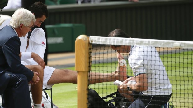 Marin Cilic receives treatment on his foot during a medical timeout in the Wimbledon final.