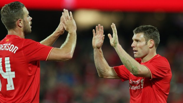 James Milner is congratulated by Liverpool captain Jordan Henderson after his 67th-minute goal.