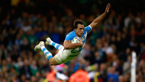Flying high: Juan Imhoff dives over the line to score his team's fourth try.