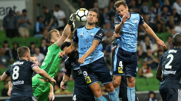 Victory keeper Lawrence Thomas under siege against Sydney FC.