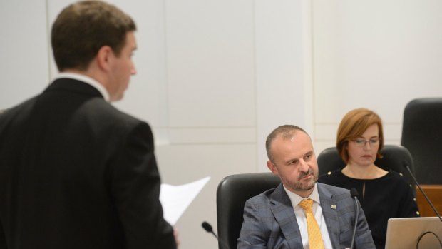 ACT Chief Minister Andrew Barr listens to Opposition leader Alistair Coe during the debate.