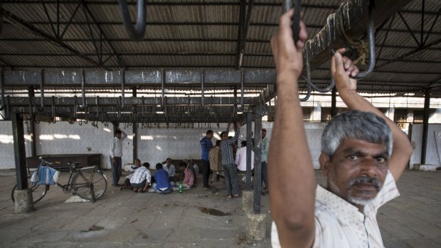 Workers strike against a ban on the slaughter of bulls and bullocks at an abattoir in Mumbai . 