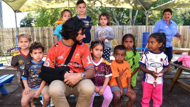 Johnathan Thurston with children from the C&K Koobara Aboriginal and Torres Strait Islander Kindergarten in Brisbane on Thursday.