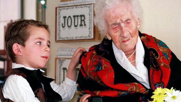 Thomas, 5, looks at Jeanne Calment after he brought her flowers at her retirement home in Arles, southern France. Calment, believed to be the world's oldest person, died at the age of 122 in 1997. 