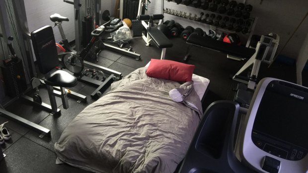 The cramped quarters at their airport station has forced some to sleep in the gym surrounded by weights. 