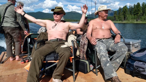 At ease: Putin laps up the sunshine.