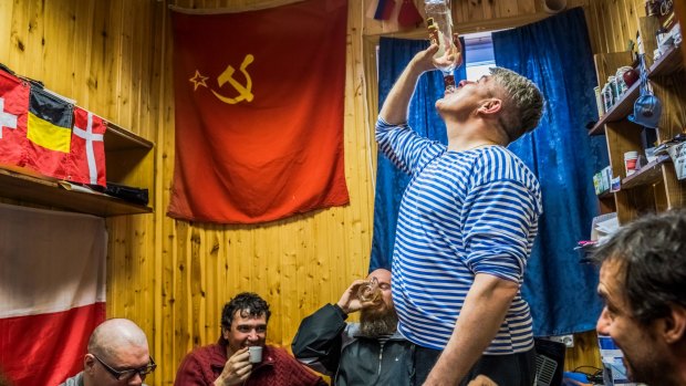Russian and Chilean researchers drink homemade vodka at the Bellingshausen Station on King George Island in Antarctica.