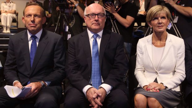 Foreign Minister Julie Bishop, pictured with Tony Abbott and George Brandis, says the Prime Minister's comments linking tsunami aid to the clemency bid for the two Australians on death row in Bali was seen as "unhelpful" by Indonesia.