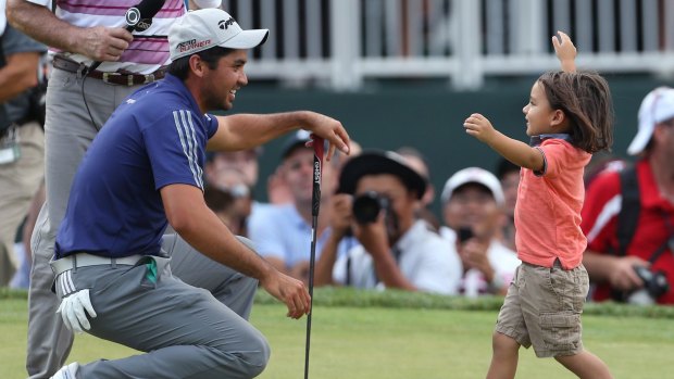 Family matters: Jason Day's son, Dash, congratulates his dad after his dominant display